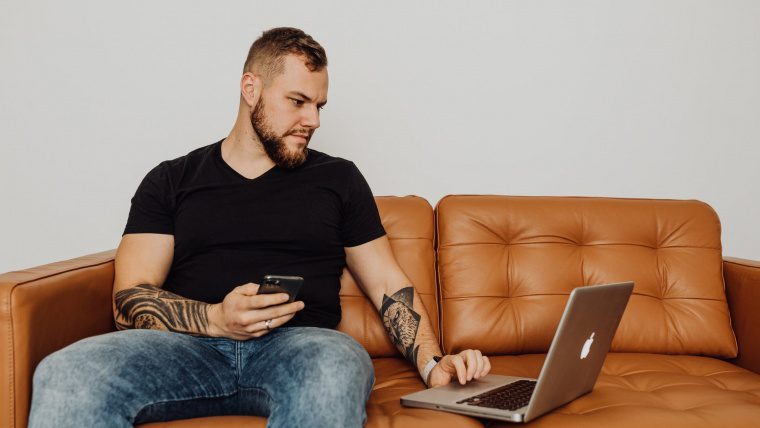 man working from home on a couch